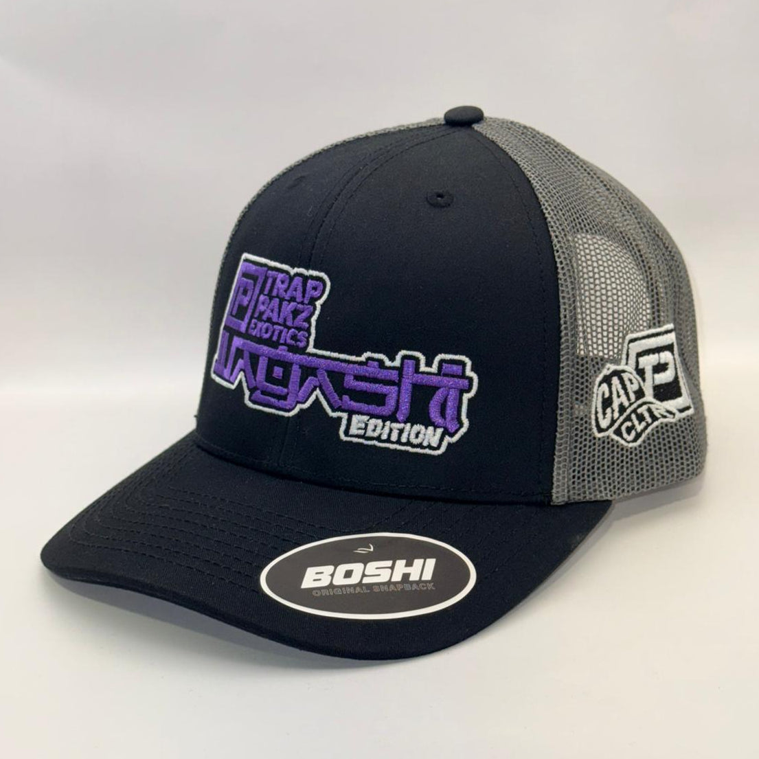 Black and gray cap with branding on a white background